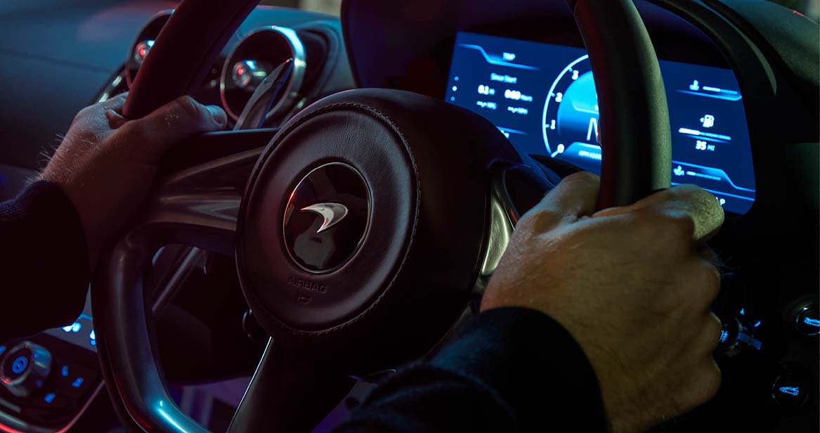 Man grasping steering wheel with drivers intent