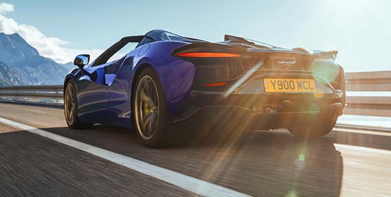 rear quarter panel of Artura speeding down a road