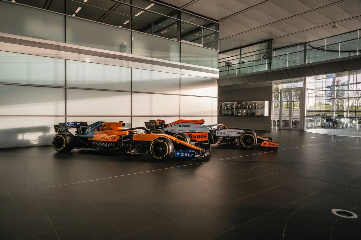 Modern papaya McLaren Formula 1 cars on display