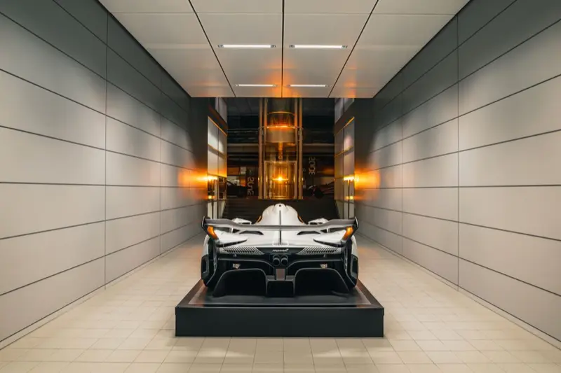 A McLaren displayed at the end of a long corridor at the McLaren Technology Centre