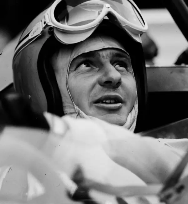 Black-and-white portrait of Bruce McLaren in his helmet and goggles