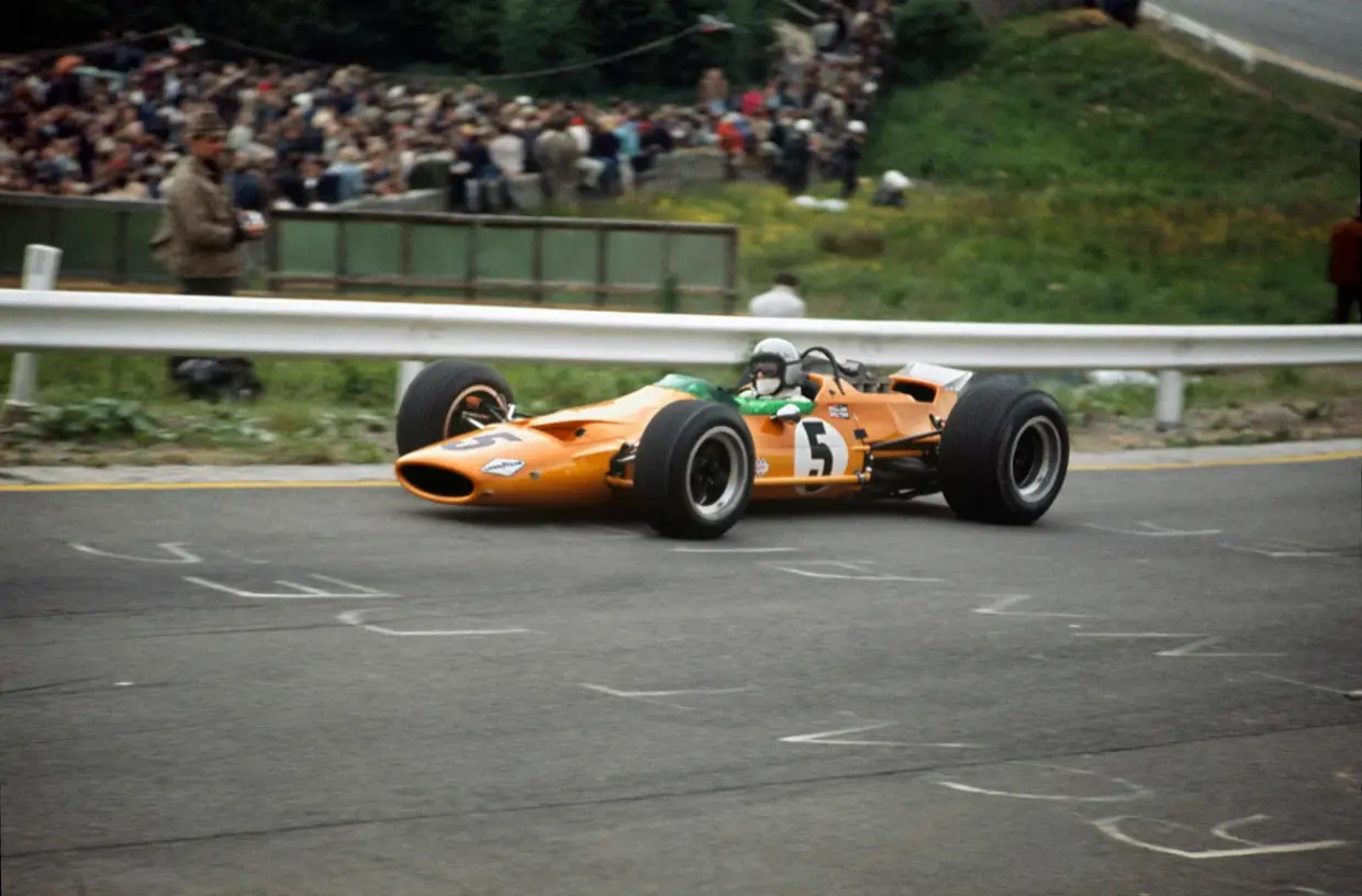 Bruce McLaren driving the papaya McLaren M7A, number 5, at the 1968 Belgian Grand Prix